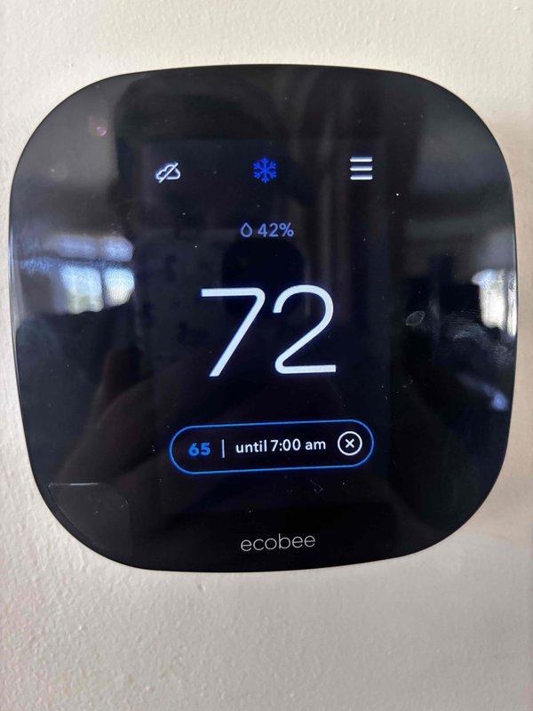 Responded to callback for 5-year-old Armstrong air conditioning system that stopped cooling again by evening after recent service visit. Upon arrival, found Ecobee smart thermostat displaying 72°F with cooling mode active and setpoint of 65°F scheduled until 7:00 AM, indicating system was calling for cooling but not achieving desired temperature. Performed diagnostic inspection of indoor air handler and verified thermostat communication. Documented equipment condition and thermostat settings with photos for service records. System evaluated for recurring cooling failure issue.