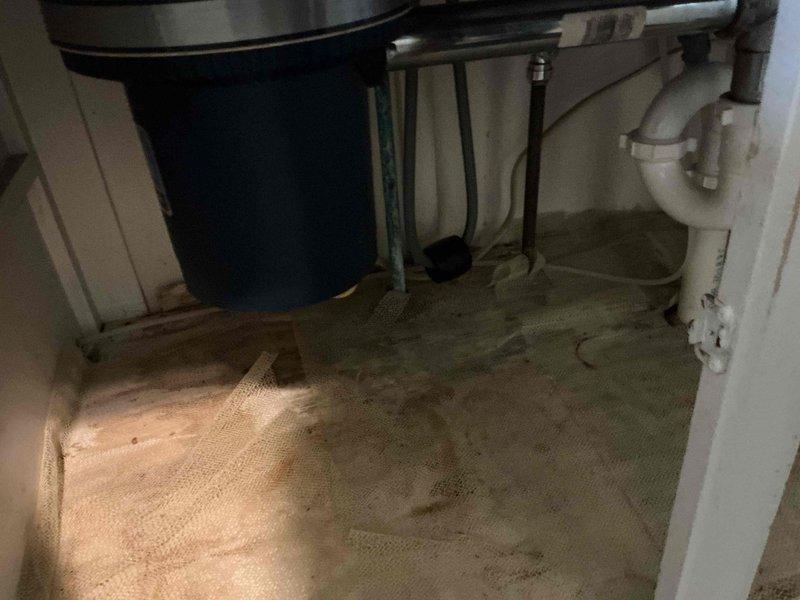 Responded to service call for garbage disposal evaluation and replacement consultation. Upon arrival, inspected under-sink plumbing configuration and existing disposal unit. Assessed cabinet interior conditions, noting moisture damage to cabinet floor liner and existing plumbing layout including water filtration system and standard P-trap drainage assembly. Discussed disposal replacement options with client and provided professional recommendations for new unit installation. Documented existing conditions with photos for reference and future work scheduling.