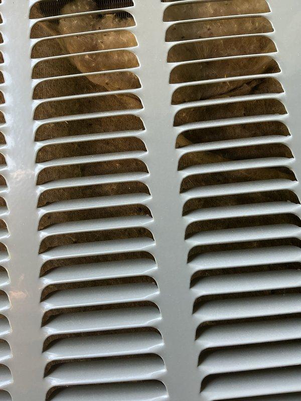 Completed annual AC tune-up and maintenance inspection per warranty agreement. Documented heavy dust and debris accumulation on supply and return air grilles throughout the system, indicating restricted airflow and potential filtration issues. Photographed corroded ventilation louvers showing rust oxidation on metal slats, which may require future replacement to maintain proper system performance and air quality.