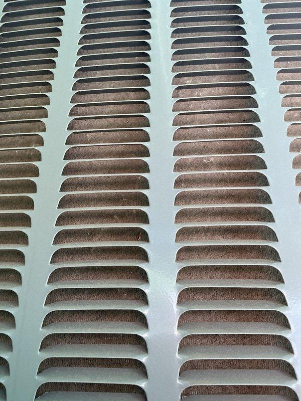 Completed annual AC tune-up and maintenance inspection per warranty agreement. Documented heavy dust and debris accumulation on supply and return air grilles throughout the system, indicating restricted airflow and potential filtration issues. Photographed corroded ventilation louvers showing rust oxidation on metal slats, which may require future replacement to maintain proper system performance and air quality.