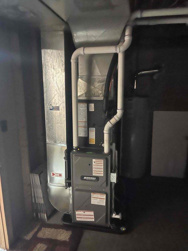 Completed full HVAC system replacement including outdoor condensing unit and indoor air handler components. Installed new outdoor condenser on existing concrete pad with proper electrical disconnect and conduit connections to building exterior. Interior installation included furnace integration with complete PVC ductwork and ventilation connections in basement utility area, ensuring proper airflow distribution throughout residence. All equipment tested and verified operational upon completion of same-day installation.