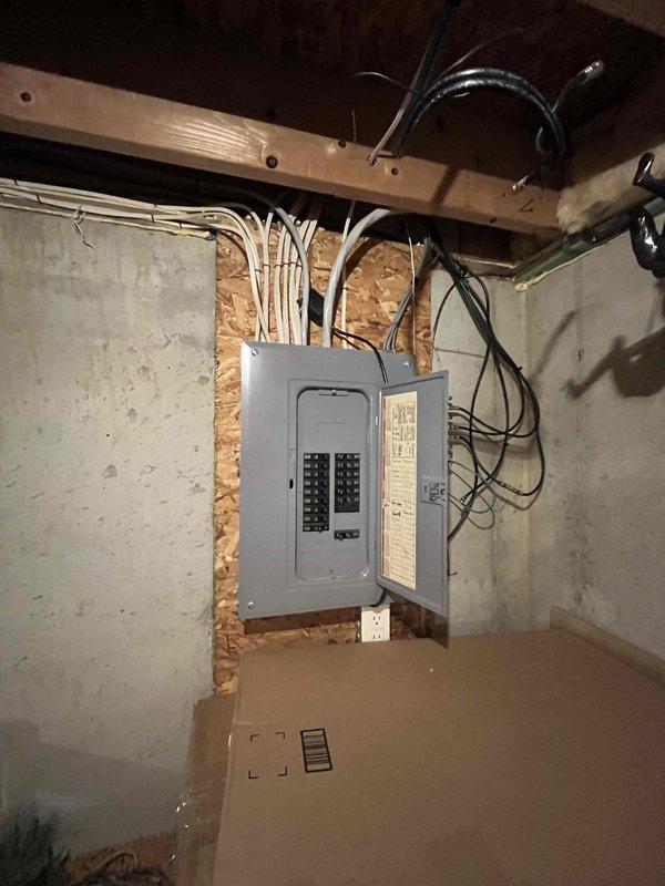 Conducted a comprehensive estimate for furnace replacement and air conditioning system installation in a residential property. The existing furnace remains operational but has reached advanced age, and the home currently has no cooling system. Evaluated the basement utility area, documenting electrical panel configuration, available space for equipment installation, and existing infrastructure including exposed joists and concrete block construction to determine optimal placement for new HVAC equipment and necessary electrical upgrades to support the additional AC unit.