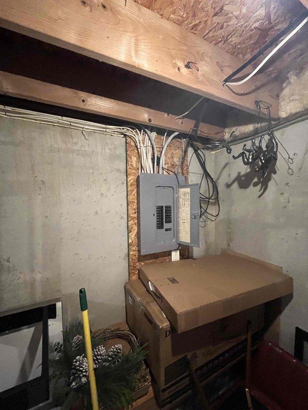 Conducted a comprehensive estimate for furnace replacement and air conditioning system installation in a residential property. The existing furnace remains operational but has reached advanced age, and the home currently has no cooling system. Evaluated the basement utility area, documenting electrical panel configuration, available space for equipment installation, and existing infrastructure including exposed joists and concrete block construction to determine optimal placement for new HVAC equipment and necessary electrical upgrades to support the additional AC unit.