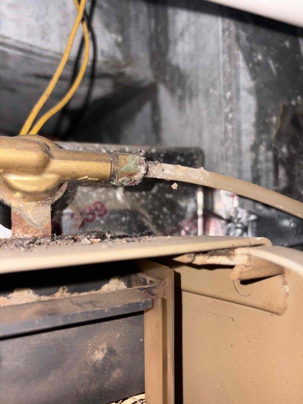 Responded to failed HVAC inspection for AMANA air conditioning unit where excessive water accumulation was found in the condensate drain pan. Cleared blockage in condensate drain line, verified proper drainage flow, and cleaned debris from drain pan to eliminate standing water. Inspected refrigerant line connections showing corrosion buildup, confirmed copper tubing integrity and proper support in drain pan, and verified all components meet code requirements for re-inspection approval.