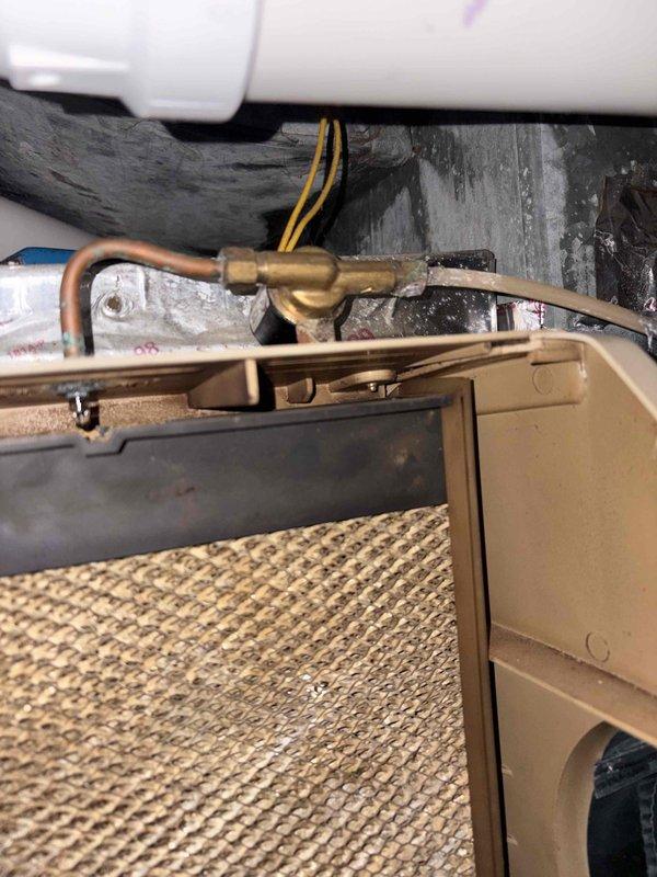 Responded to failed HVAC inspection for AMANA air conditioning unit where excessive water accumulation was found in the condensate drain pan. Cleared blockage in condensate drain line, verified proper drainage flow, and cleaned debris from drain pan to eliminate standing water. Inspected refrigerant line connections showing corrosion buildup, confirmed copper tubing integrity and proper support in drain pan, and verified all components meet code requirements for re-inspection approval.