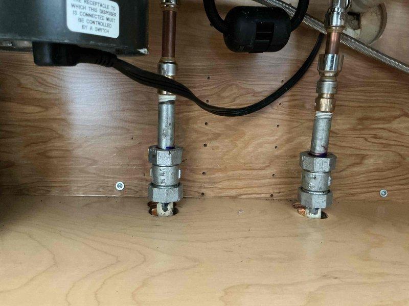 Returned for follow-up service to address sink fitting issue from previous visit. Inspected plumbing connections under sink where fittings had detached after initial repair attempt. Provided hands-on instruction to client on proper installation technique for sink fittings to ensure secure connection. Documented existing plumbing configuration including galvanized steel pipe assemblies, flexible supply lines, and PVC drainage connections in crawl space area.