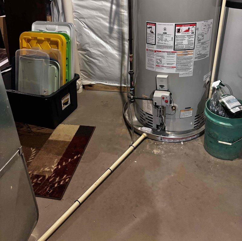 Installed condensate drain tube on Bradford White water heater at no charge to address calcification issues caused by condensation from previously extended venting line. The installation was completed as a courtesy follow-up to resolve moisture-related problems that developed after the initial water heater installation and vent modification work.