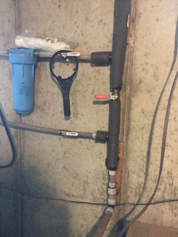 Responded to service call for non-functional Morton water softener system. Upon arrival, inspected the complete water treatment installation including pre-filtration system with blue canister housing and associated piping configuration. Evaluated the water softener unit, plumbing connections, bypass valve assembly, and drain line routing. Identified issue with system operation and performed necessary adjustments to restore proper functionality. Verified water flow through filtration system and softener unit, confirmed proper drain line installation and trap assembly, and tested system cycling. Unit returned to normal operating condition with all components functioning as designed.