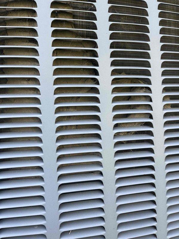 Completed annual cooling maintenance on 9-year-old EnergiAir system under warranty through November 2026. Inspection revealed significant dirt and debris accumulation on exterior ventilation louvers and condenser coils, particularly in upper sections. Documented equipment condition with photographs showing contaminated coil fins and soiled air intake grills requiring attention for optimal system performance.