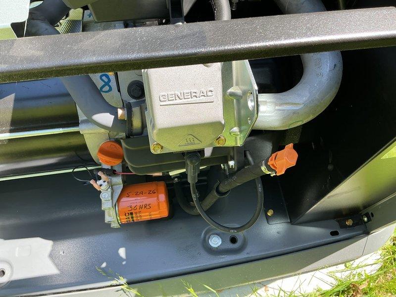 Performed generator tune-up and maintenance inspection on Generac unit displaying yellow warning indicator for battery inspection. Conducted comprehensive system evaluation including visual inspection of all accessible components, electrical connections, and mounting hardware. Verified proper operation of control panel interface and documented equipment condition with photographic records. Unit appears to be in functional condition with 1-year Honeywell warranty active through April 2027. Recommended continued monitoring of battery status per manufacturer specifications.