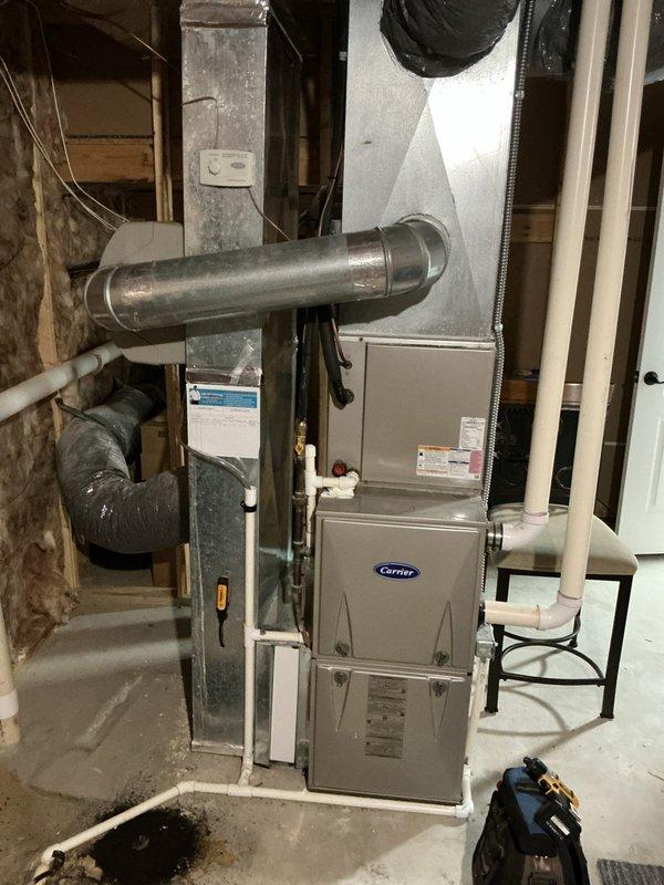 Completed annual cooling maintenance on 15-year-old Carrier HVAC system. Inspected indoor furnace unit in basement and outdoor condenser unit, verified proper operation of all components, checked refrigerant levels, cleaned condenser coils, and tested system performance. All equipment operating within normal parameters; documented system condition with photos for service records.