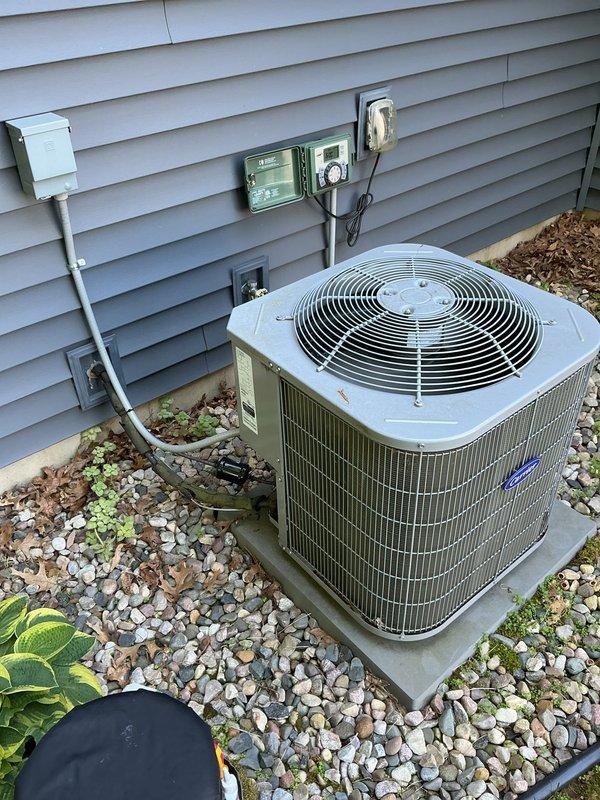 Completed annual cooling maintenance on 15-year-old Carrier HVAC system. Inspected indoor furnace unit in basement and outdoor condenser unit, verified proper operation of all components, checked refrigerant levels, cleaned condenser coils, and tested system performance. All equipment operating within normal parameters; documented system condition with photos for service records.