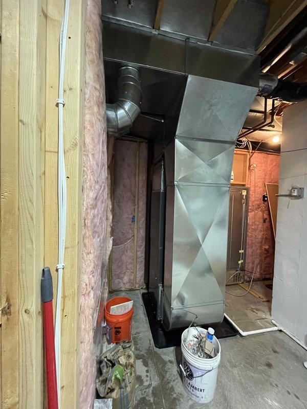 Completed full HVAC system installation including new furnace and air conditioning unit at residential property. Installed outdoor condensing unit on concrete pad with proper clearances, connected refrigerant lines and electrical conduit to existing Generac transfer switch panel. Interior installation included new furnace with supply and return ductwork in basement mechanical room, utilizing metal trunk lines and transitions. All equipment properly mounted, leveled, and secured per manufacturer specifications. System startup performed, refrigerant charge verified, and all electrical connections tested for proper operation.