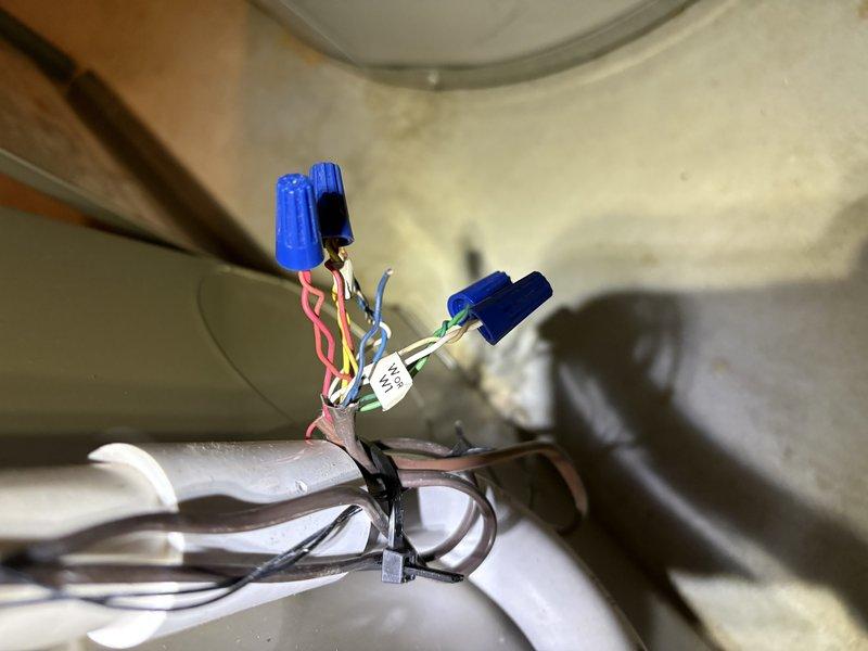 Responded to no-cooling call on 25-year-old residential air conditioning system. Upon arrival, found complete system failure with no power to outdoor condenser unit. Inspected electrical connections at indoor air handler and outdoor disconnect. Discovered failed wire connections at junction point with deteriorated wire nuts causing open circuit. Removed old connectors, stripped wire ends, and reinstalled proper wire terminations using new wire nuts and secured all connections. Restored power to system and verified compressor and condenser fan motor operation. Unit cycled properly with normal amperage draw and airflow. System returned to full cooling operation.