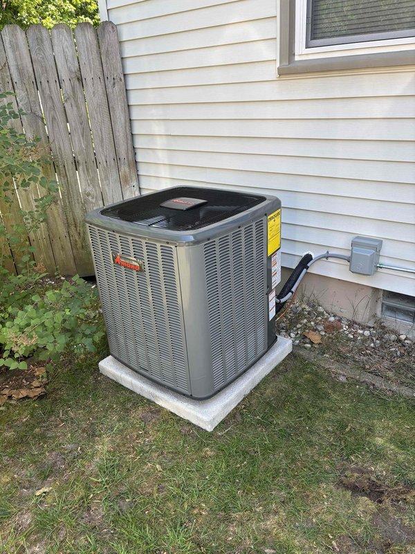 Successfully completed add-on air conditioning system installation to existing forced-air heating system. Installed new outdoor condensing unit on level concrete pad against exterior wall with proper clearances maintained from fence line and structure. Mounted electrical disconnect box on exterior siding and ran refrigerant line set and electrical conduit from outdoor unit into mechanical room. Inside utility closet, integrated new air handler component with existing furnace system. Installed proper PVC venting through roof for combustion air and exhaust. All refrigerant lines properly insulated and secured along exterior wall. System tested for proper operation, refrigerant charge verified, and airflow balanced. Fire safety equipment confirmed in place within mechanical room. Installation meets all code requirements with professional routing of all utilities and proper equipment placement for serviceability.