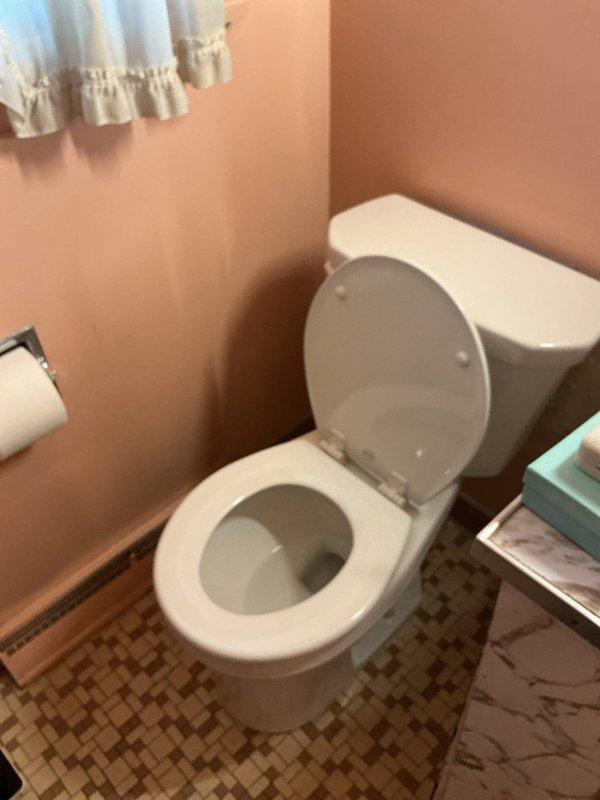 Responded to emergency toilet repair at residence where the only toilet had failed, requiring the homeowner to shut off the main water supply due to the absence of a dedicated fixture shut-off valve. Upon arrival, assessed the toilet malfunction in the compact bathroom with mosaic tile flooring and peach walls. Completed necessary repairs to restore the toilet to proper working condition, eliminating the need for the main water shutoff and restoring full water service to the home.