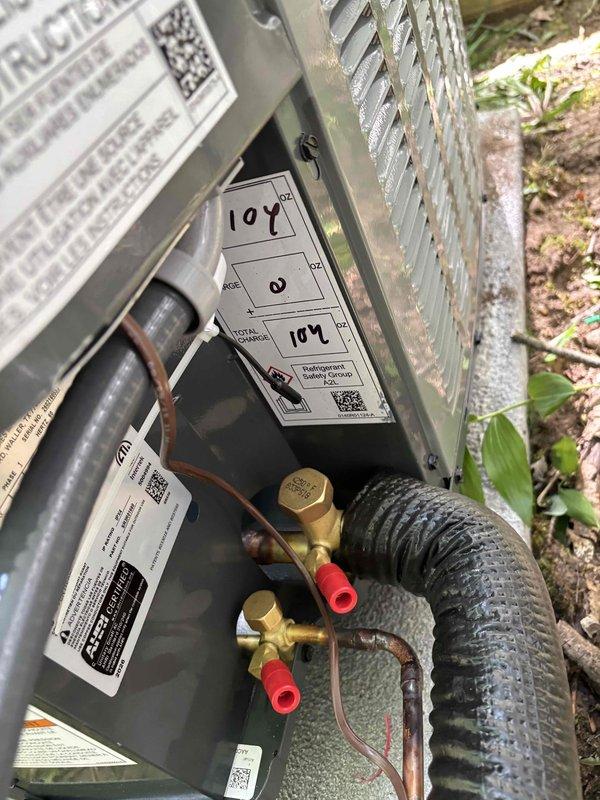 Completed full air conditioning system installation including outdoor condensing unit and indoor evaporator coil integration with existing furnace. Installed and connected copper refrigerant lines with proper insulation, established electrical connections, and integrated new AC components with current heating system. Charged system with refrigerant, verified proper operation of all components, and confirmed airflow through existing ductwork. Tested system performance with temperature differential readings showing 107°F and 104°F at service ports, indicating proper refrigerant charge and system operation. Installed required venting modifications using PVC piping for condensate drainage and secured all connections per manufacturer specifications. System operational and performing within normal parameters upon completion.