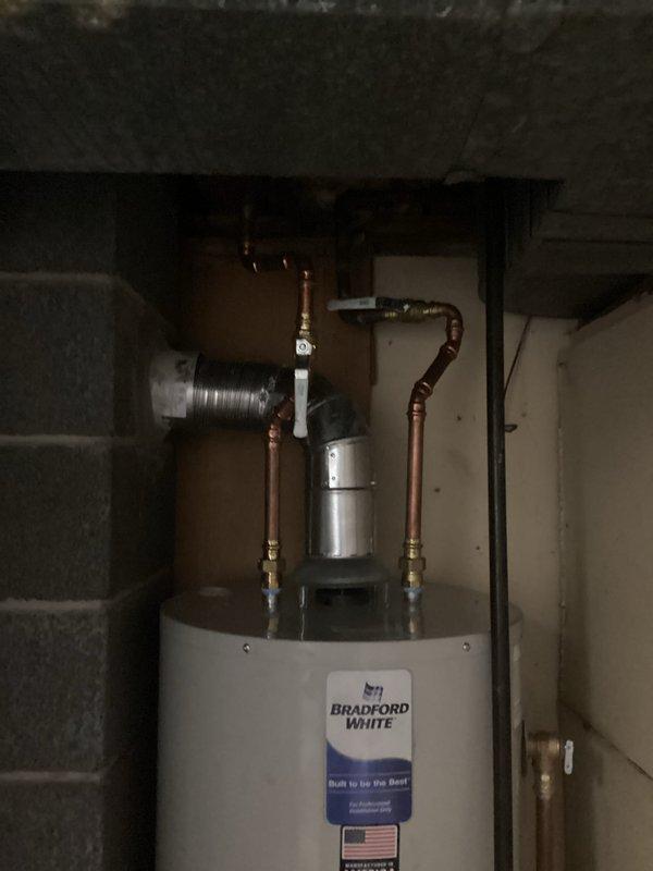 Removed and disposed of existing water heater unit. Installed new 40-gallon tall Bradford White water heater with proper copper piping connections and brass fittings. Installed 4-inch chimney liner for proper venting of combustion gases. All connections tested and verified operational, with 6-year parts warranty and 1-year labor warranty provided on installation.