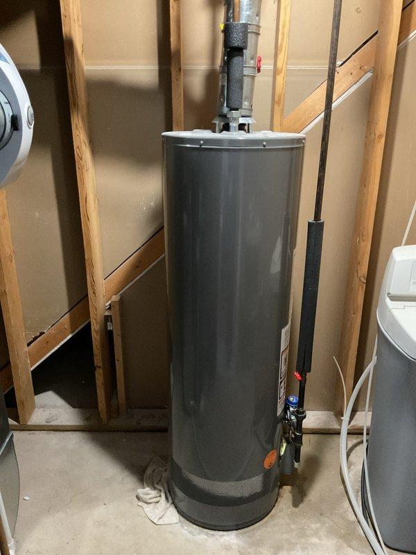 Responded to service call for leaking water heater approximately 10 years old. Upon arrival, inspected unit installed in unfinished basement utility area and identified active leak requiring immediate attention. Due to age of unit and extent of deterioration, recommended and completed full water heater replacement with new residential gas water heater, including proper venting with PVC exhaust pipe, copper supply line connections with brass fittings and shutoff valves, and black foam pipe insulation on hot and cold water lines to prevent heat loss and condensation.