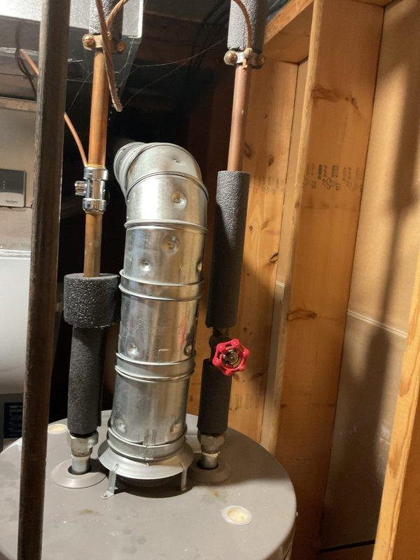 Responded to service call for leaking water heater approximately 10 years old. Upon arrival, inspected unit installed in unfinished basement utility area and identified active leak requiring immediate attention. Due to age of unit and extent of deterioration, recommended and completed full water heater replacement with new residential gas water heater, including proper venting with PVC exhaust pipe, copper supply line connections with brass fittings and shutoff valves, and black foam pipe insulation on hot and cold water lines to prevent heat loss and condensation.
