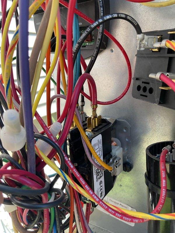 # NC-No Cool Service Completed

Responded to no cooling complaint on 2-year-old EnergiAir system. Upon arrival, performed diagnostic testing using refrigerant manifold gauges and digital multimeter to assess system operation. Inspection revealed electrical control issues requiring attention to wiring connections at the condensing unit. Accessed electrical panel and examined CoreSense control board, contactor assembly, and dual-run capacitor (38/5 MFD). Verified proper wire terminations and electrical connections throughout the control circuit. Tested refrigerant pressures on both high and low sides of the system using professional-grade manifold gauge set with color-coded hoses. System restored to proper cooling operation following diagnostic work and necessary corrections to electrical connections.