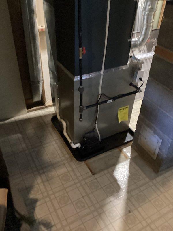 Completed full air conditioning system installation including indoor air handler unit mounted on drain pan in utility area with refrigerant lines properly insulated and connected. Installed outdoor condensing unit on concrete pad with all electrical connections, refrigerant line sets, and condensate drainage completed per manufacturer specifications. System tested and verified operational with all components functioning properly.