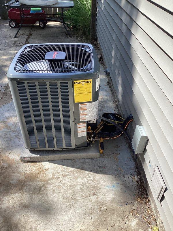 Completed full air conditioning system installation including indoor air handler unit mounted on drain pan in utility area with refrigerant lines properly insulated and connected. Installed outdoor condensing unit on concrete pad with all electrical connections, refrigerant line sets, and condensate drainage completed per manufacturer specifications. System tested and verified operational with all components functioning properly.