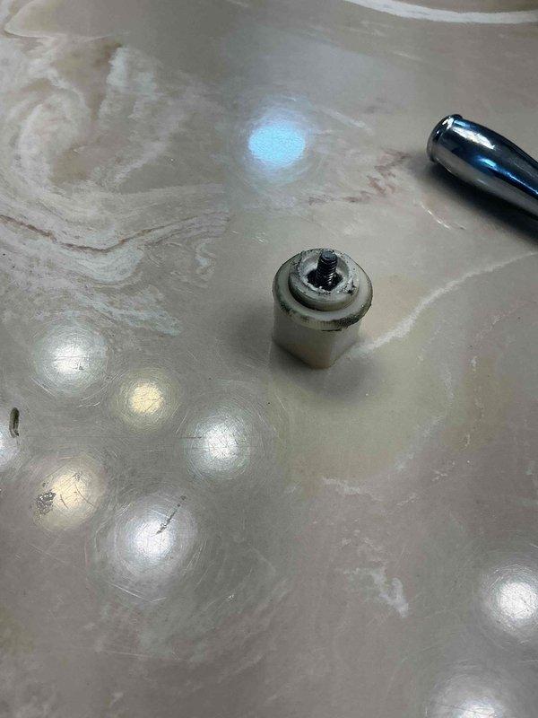 Responded to shower faucet failure with loose, spinning handle and no water delivery. Upon inspection, found valve stem had become detached from cartridge assembly, causing handle to spin freely without engaging water control mechanism. Removed decorative trim and handle to access valve cartridge. Replaced faulty cartridge and reinstalled handle assembly, securing all components properly. Tested operation and confirmed full water flow restoration and proper temperature control functionality.