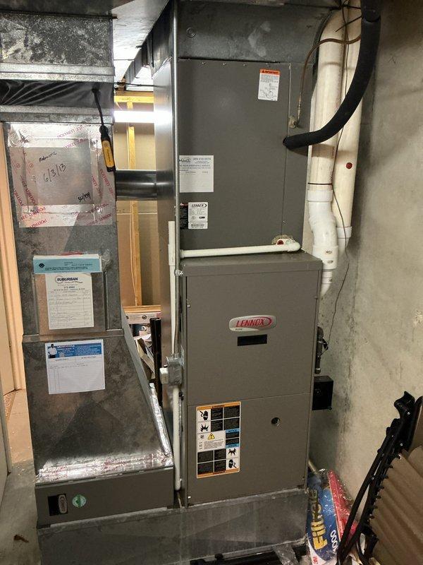 Completed comprehensive AC tune-up on 15-year-old Lennox system located in basement mechanical room. Performed standard maintenance protocol including inspection of furnace and air handler components, verified all manufacturer labels and specifications, checked electrical connections with yellow conduit routing, inspected black flexible ductwork and white PVC drainage piping for proper operation, and documented system condition with photographs. All equipment operating within normal parameters with no immediate service concerns identified.
