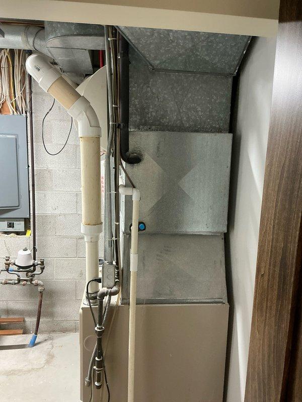 Conducted comprehensive assessment of 15-year-old furnace and air conditioning system for replacement estimate. Both units currently operational but customer pursuing proactive replacement due to equipment age to prevent potential system failures. Documented existing HVAC installation including furnace with galvanized ductwork, air handling components, and associated electrical and gas line connections in basement utility area. Photographed current system configuration, exposed plumbing infrastructure, PVC drainage lines, copper wiring, and structural mounting to provide detailed reference for replacement planning. Provided equipment replacement options and recommendations based on current system specifications and customer's preventative maintenance objectives.