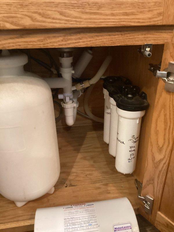 Performed comprehensive plumbing system evaluation addressing multiple concerns. Inspected reverse osmosis filtration system under kitchen sink, verified filter condition and system operation. Serviced bathroom faucet with stiff handles, disassembled three-piece chrome faucet assembly on undermount vanity sink to address difficult operation of hot and cold water controls. Consulted with homeowner regarding septic backup system options and recommendations for property protection.