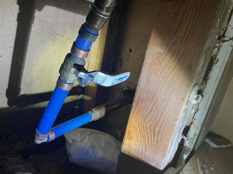 Responded to recurring failure of exterior spigot supply line. Upon inspection, discovered deteriorated connection between galvanized supply piping and outdoor faucet assembly in crawl space beneath structure. Replaced failed section with new PVC piping, installed quarter-turn ball valve shutoff for future maintenance access, and secured proper connections using threaded metal fittings to transition between existing galvanized pipe and new blue PVC supply line. All connections tested and verified leak-free under pressure.