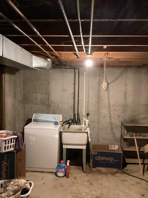 Completed full air conditioning system replacement at residential property. Removed existing outdoor condensing unit and installed new AC system with proper refrigerant line connections, electrical hookup, and condensate drainage. Indoor air handler component installed in basement location with secure mounting, ductwork connections to existing distribution system, and proper clearances maintained for service access. All refrigerant lines pressure tested, evacuated, and charged to manufacturer specifications. System startup performed with verification of proper airflow, temperature differential across coil, amperage draw within acceptable range, and thermostat communication. All safety controls and disconnect switches tested and operational.