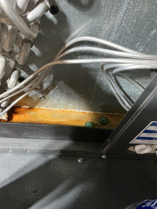 Completed annual cooling maintenance on 7-year-old Goodman air conditioning system. Performed comprehensive tune-up including inspection of evaporator coil and condensate management components. System observed operating with normal condensation accumulation during cooling cycle. Verified condensate drainage system functionality and proper water removal from drain pan. Inspected refrigerant lines and insulation condition, noting some wear on foam insulation material. Evaluated air handler components and coil housing for proper operation. Documented system conditions with photographs showing active condensation and frost formation consistent with normal cooling operation. All maintenance procedures completed per manufacturer specifications and industry standards.