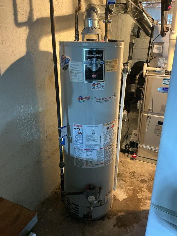 Completed estimate for replacement of existing 40-gallon Bradford White water heater with Defender Safety System. Documented current installation including copper and PEX plumbing connections, exhaust venting configuration, and clearance requirements in basement utility room. Photographed existing equipment specifications and surrounding HVAC components to provide accurate replacement proposal.