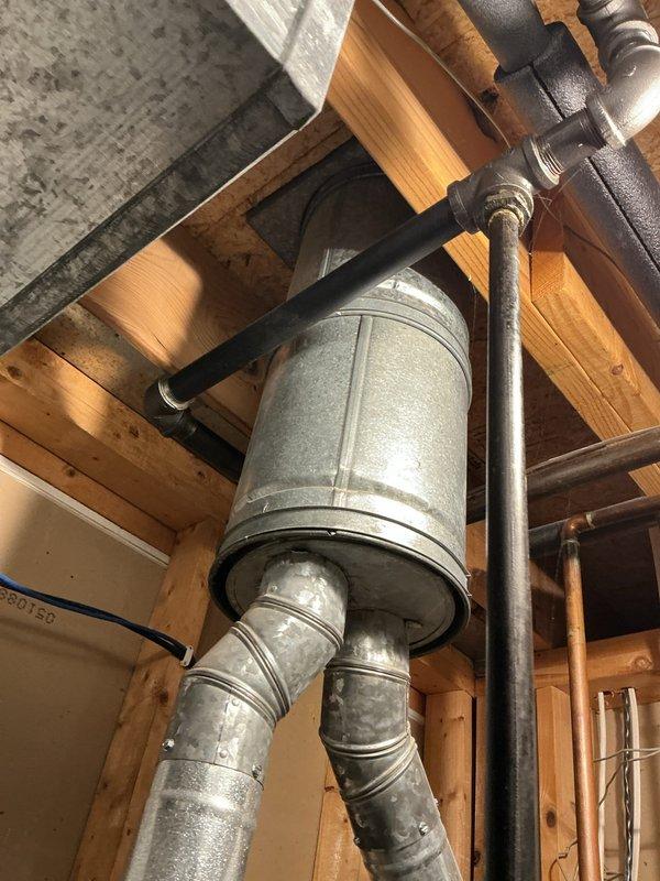 Completed estimate for replacement of two residential water heaters in utility room, with one unit actively leaking. Assessed existing installation including dual water heater configuration with interconnected copper piping, brass valves, galvanized venting system, and associated gas lines. Documented current plumbing infrastructure, vent routing through ceiling joists, and electrical connections to provide accurate replacement specifications and scope of work.