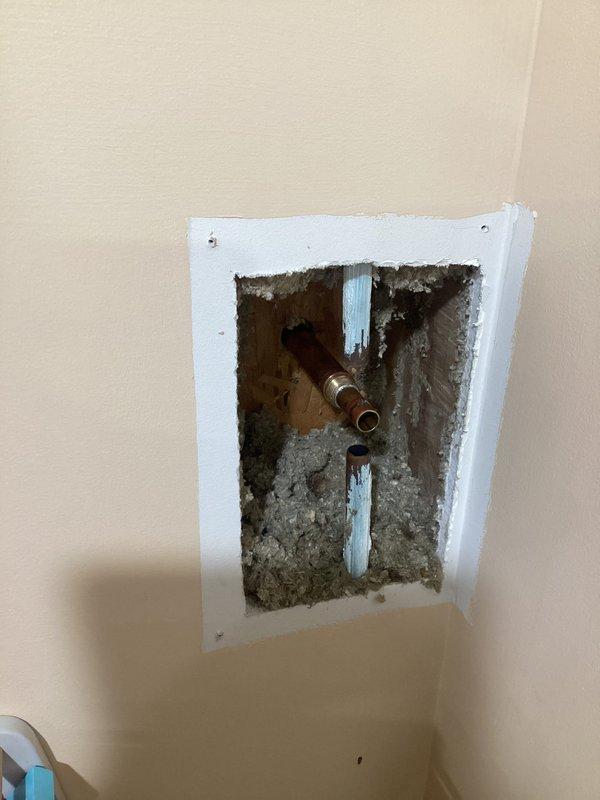 Responded to service call for leaking outdoor water spigot at residential property. Upon inspection, accessed plumbing system through ceiling cavity to locate source of leak at copper pipe connection serving exterior hose bib. Repaired faulty valve connection with oxidized copper piping, replaced worn components, and verified system integrity. Created access opening in wall/ceiling to reach affected plumbing, completed repairs, and confirmed no active leaks present upon completion.