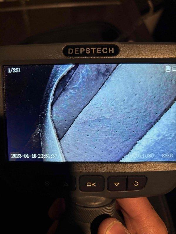 Responded to cooling complaint regarding system not maintaining thermostat setpoint on 9-year-old Lennox air conditioning unit. Performed diagnostic inspection of HVAC system in basement utility area. Utilized borescope camera equipment to conduct internal inspection of ductwork and system components to identify potential airflow restrictions or mechanical issues. Documented equipment conditions and system configuration including condensate drainage lines, mechanical connections, and air handler assembly. Investigation revealed need for further assessment of system performance and capacity relative to cooling load demands.