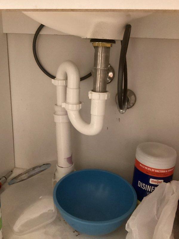 Responded to multiple plumbing concerns in a 35-year-old residential property. Addressed basement bathroom faucet leak by inspecting undermount sink with chrome single-handle faucet and examining cabinet plumbing connections including P-trap assembly, supply lines, and shut-off valves. Verified proper drainage function and checked for any additional leaks in the vanity plumbing system. All fixtures photographed and documented for service records.