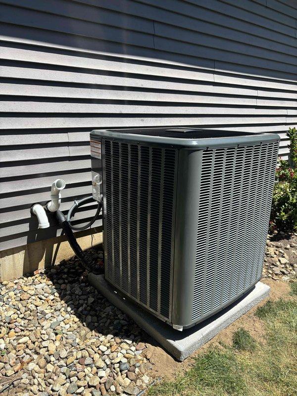 Completed full installation of new furnace and air conditioning system. Furnace unit was installed in basement utility area on platform base with proper venting via PVC piping and electrical connections to panel box. Outdoor condenser unit was positioned on concrete pad with rock bed for drainage, refrigerant lines were run and secured to exterior wall with proper line sets, and electrical conduit was installed. All ductwork connections were completed, system was charged, and full operational testing was performed to verify heating and cooling functionality.