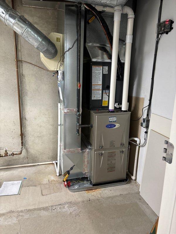 Completed full HVAC system replacement including outdoor condensing unit and indoor air handler. Installed new Carrier condensing unit on existing concrete pad with proper refrigerant line connections and electrical conduit routing along exterior wall. Replaced indoor furnace and air handler assembly in basement mechanical room with new Carrier equipment. Installed PVC condensate drainage piping and connected all ductwork to new system. Verified proper refrigerant charge, tested all electrical connections, and confirmed system operation. Unit operating within manufacturer specifications upon completion.