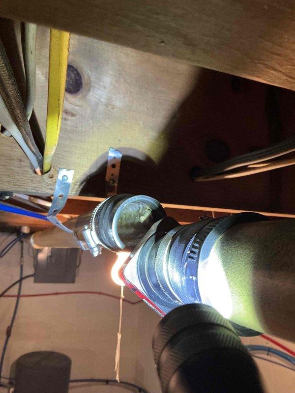 Responded to kitchen sink drain blockage that was not resolved by previous snaking attempts or chemical drain cleaner. Inspected under-sink plumbing configuration including garbage disposal and PVC drain lines. Accessed drain system from basement crawlspace and identified blockage in horizontal drain run between floor joists. Successfully cleared obstruction and restored proper drainage flow to kitchen sink.