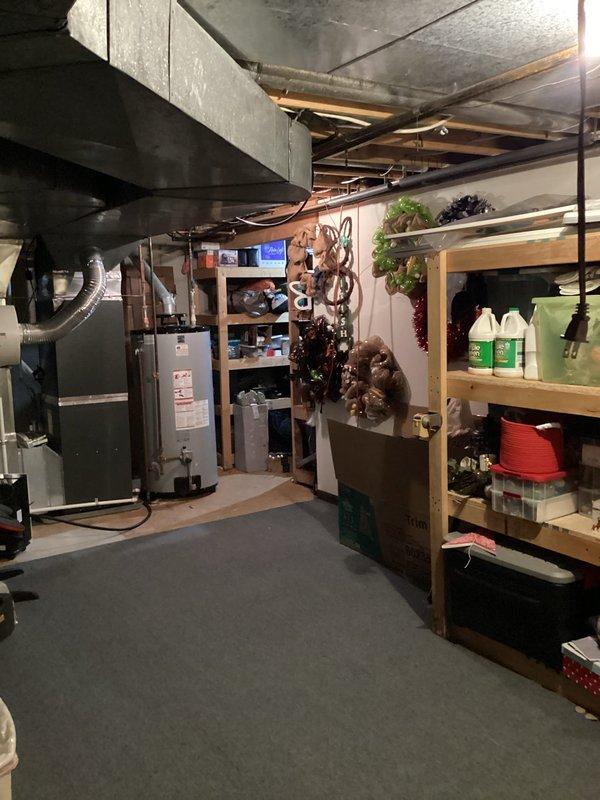 Responded to emergency gas leak call with whole home system shut down. Upon arrival, inspected 5-year-old heating system and associated gas lines in basement utility area. Located and assessed small gas leak in vicinity of furnace and exposed piping system. Verified system shutdown for safety, investigated leak source among copper pipes and gas supply lines visible in mechanical space. Documented conditions with photographs showing exposed ceiling infrastructure, ductwork, refrigerant lines, and furnace installation. Addressed immediate safety concerns and restored safe operation of heating system.