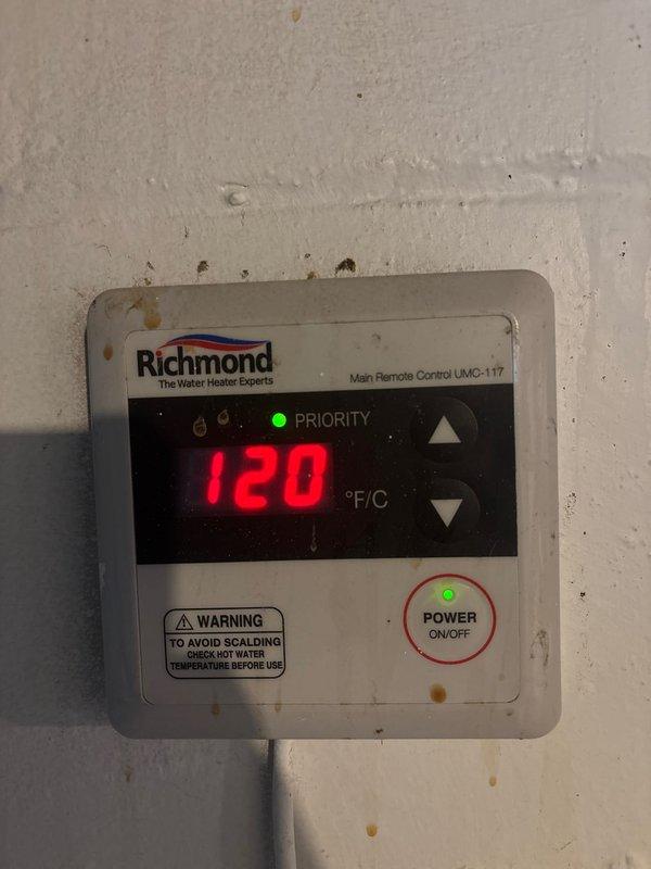 Responded to service call for 9-year-old Richmond tankless water heater experiencing intermittent beeping during high-demand usage (laundry, bathtub filling). Inspected unit and main remote control panel (UMC-117) currently set at 120°F with priority mode active. Reviewed manufacturer service error code chart to diagnose potential causes of audible alarm. Determined beeping likely related to demand/flow rate issues when multiple fixtures operate simultaneously or during high-volume draws. Unit continues to function properly for lower-demand applications such as showers and sink usage, indicating heating elements and basic operation remain functional but system may be approaching capacity limits or experiencing scaling buildup affecting flow sensors.