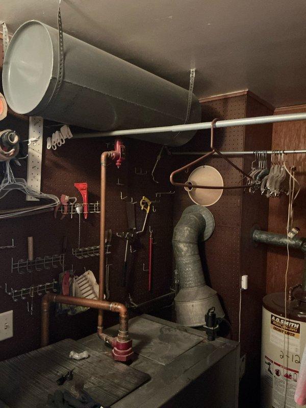 Conducted on-site assessment for AC system replacement estimate at residence with existing boiler heating system, estimated to be original to 1960s construction. Inspected current mechanical room configuration including hot water boiler, ductwork, water heater, and utility space layout to determine feasibility and requirements for new air conditioning installation. Documented existing equipment conditions and spatial considerations for future HVAC system integration.
