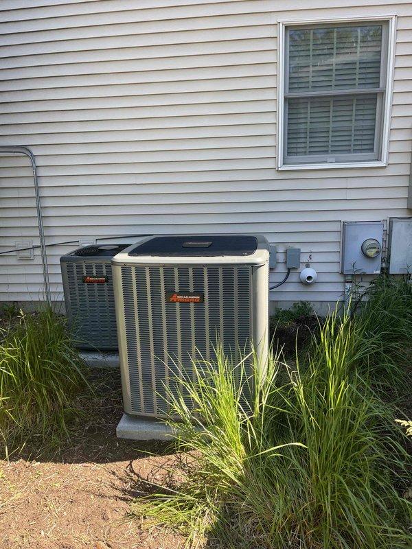 Completed full HVAC system replacement including outdoor condensing unit and indoor furnace. Removed existing equipment and installed new Energy-branded furnace in utility closet with proper venting using white PVC piping configured with multiple elbows for exhaust and intake. Installed new outdoor AC condenser unit on existing concrete pad with beige metal casing, connected electrical service including disconnect box, and completed refrigerant line connections. Verified all electrical connections, tested system operation, and confirmed proper airflow through ductwork. System commissioned and operational upon completion.