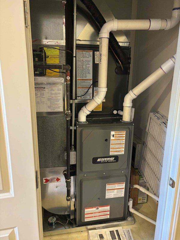 Completed full HVAC system replacement including outdoor condensing unit and indoor furnace. Removed existing equipment and installed new Energy-branded furnace in utility closet with proper venting using white PVC piping configured with multiple elbows for exhaust and intake. Installed new outdoor AC condenser unit on existing concrete pad with beige metal casing, connected electrical service including disconnect box, and completed refrigerant line connections. Verified all electrical connections, tested system operation, and confirmed proper airflow through ductwork. System commissioned and operational upon completion.