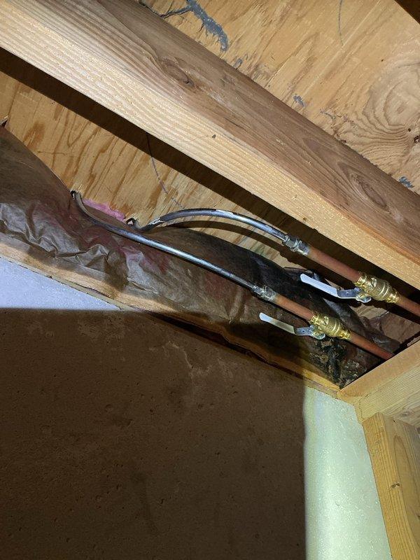 Responded to plumbing leak service call for leaking valve in garage area connected to downstairs plumbing system. Inspected and addressed leak at valve junction between lower level and garage, examining exposed piping and connections in ceiling/wall cavity. Also performed requested inspection of pressure switch and conducted brief evaluation of kitchen sink plumbing as part of comprehensive service visit.