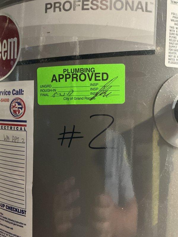 Completed rental inspection of basement mechanical room containing multiple water heaters and furnace system. Documented equipment conditions, verified proper installation of HVAC ductwork, plumbing connections with copper piping and blue-handled valves, and confirmed presence of city plumbing inspection approval stickers on units. Photographed all equipment including Bradford White and Integra branded water heaters for rental property compliance records.