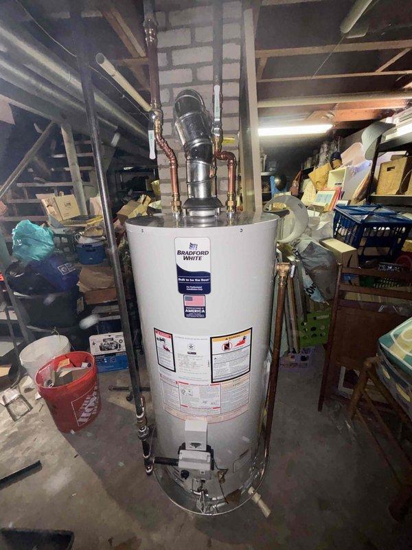 Completed full HVAC system installation including new furnace, air conditioning unit, and water heater at residential property. Installed Trane condenser unit on exterior concrete pad with proper refrigerant line routing and insulation penetrating building envelope. Installed Bradford White water heater in basement utility area with copper supply piping, pressure relief valve assembly, and all code-required safety components and labeling.